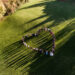 Wedding guests lined up in the shape of heart with bride and groom marriage people