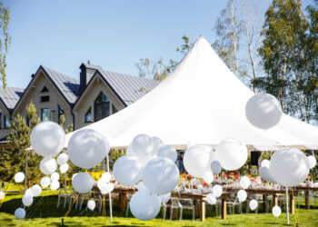 Wedding tent with large balls. Tables sets for wedding or another catered event dinner.
