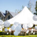 Wedding tent with large balls. Tables sets for wedding or another catered event dinner.